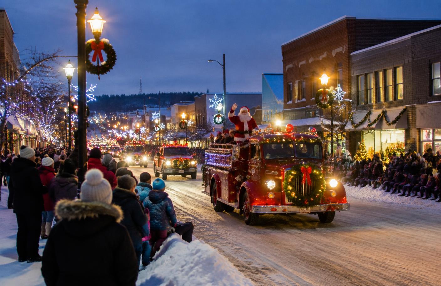 Winter parade with holiday lights along a downtown Timmins street